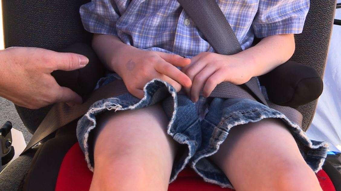 Keri Gibson encourages parents make sure the lap and shoulder belts are in the proper place on their child's booster seat. (Photo: KSL TV)