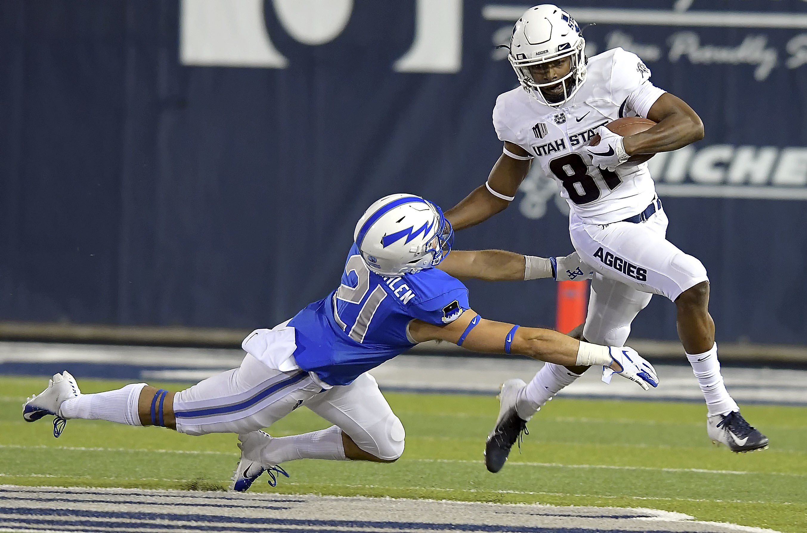 Utah State wide receiver Savon Scarver (81) stiff arms Air Force defensive back Bryce VonZurmuehlen (21) on a kickoff return during an NCAA college football game, Saturday, Sept. 22, 2018, in Logan, Utah. (Eli Lucero/The Herald Journal via AP)