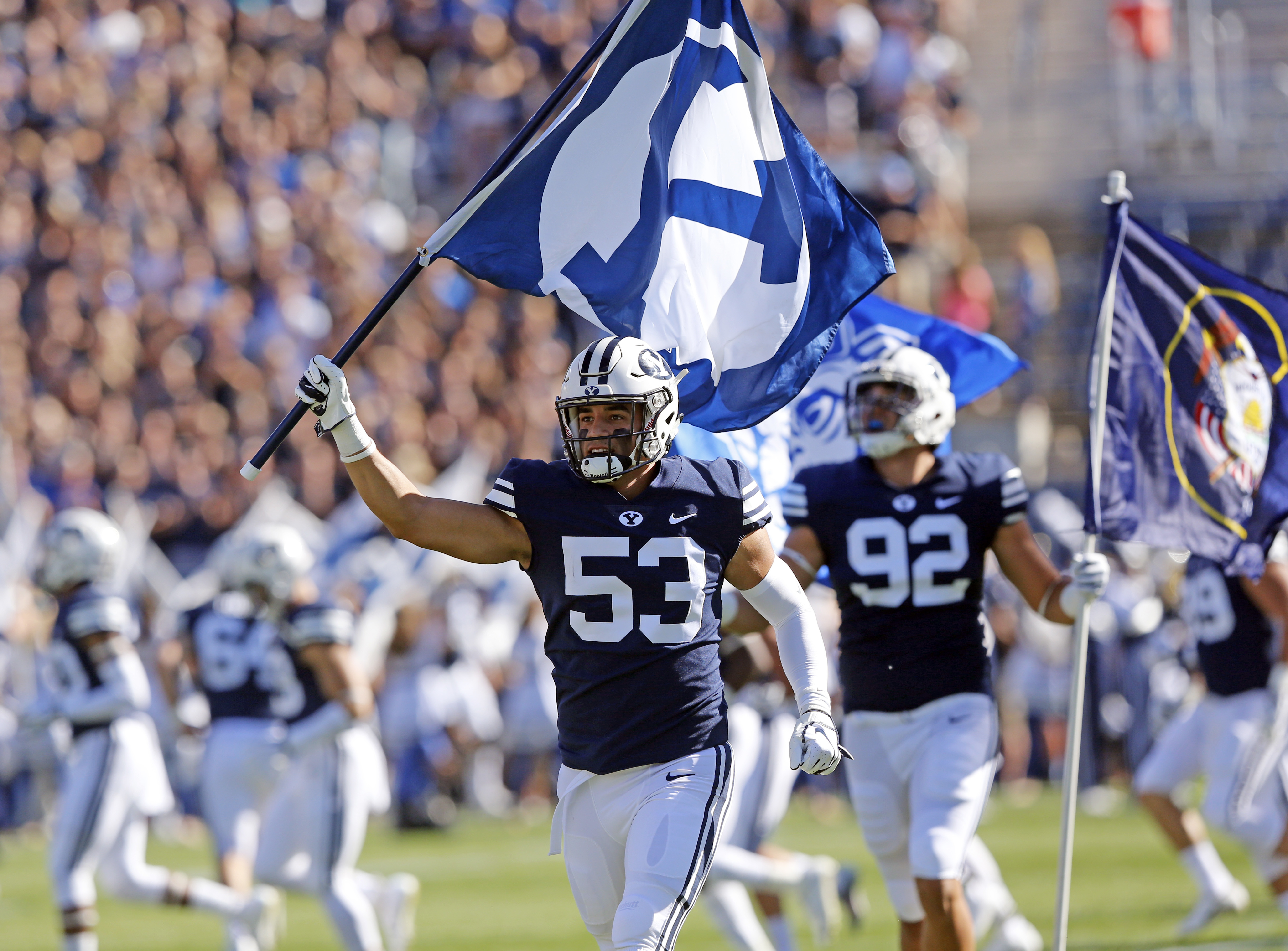 BYU's Isaiah Kaufusi (53) and Devin Kaufusi (92) run on to the field before the start of their NCAA college football game against McNeese State Saturday, Sept. 22, 2018, in Provo, Utah. (Photo: Rick Bowmer, AP)