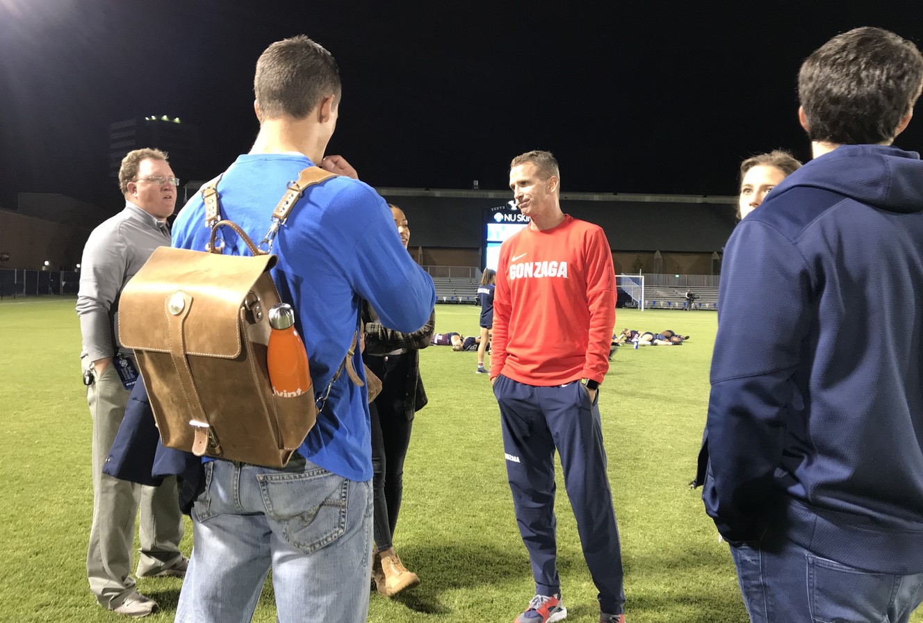 Former BYU soccer coach Chris Watkins, center in red, meets with several former players after the Cougars' 3-1 win over Gonzaga. After 23 seasons at BYU, Watkins was named the head coach at Gonzaga in 2017. (Photo: Sean Walker, KSL.com)