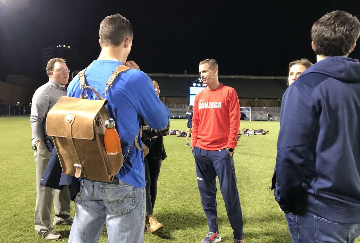 Former BYU soccer coach Chris Watkins, center in red, meets with several former players after the Cougars' 3-1 win over Gonzaga. After 23 seasons at BYU, Watkins was named the head coach at Gonzaga in 2017. (Photo: Sean Walker, KSL.com)