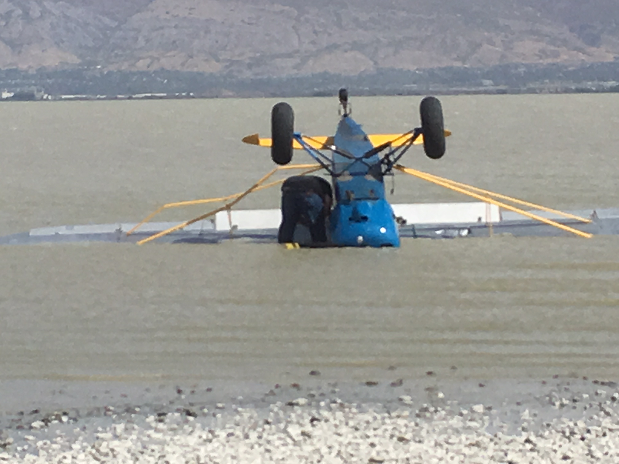 A pilot walked away from his plane with only minor injuries after landing upside down in the shallow waters of Utah Lake on Saturday, Sep. 29, 2018. (Photo: Utah County Sheriff's Office)