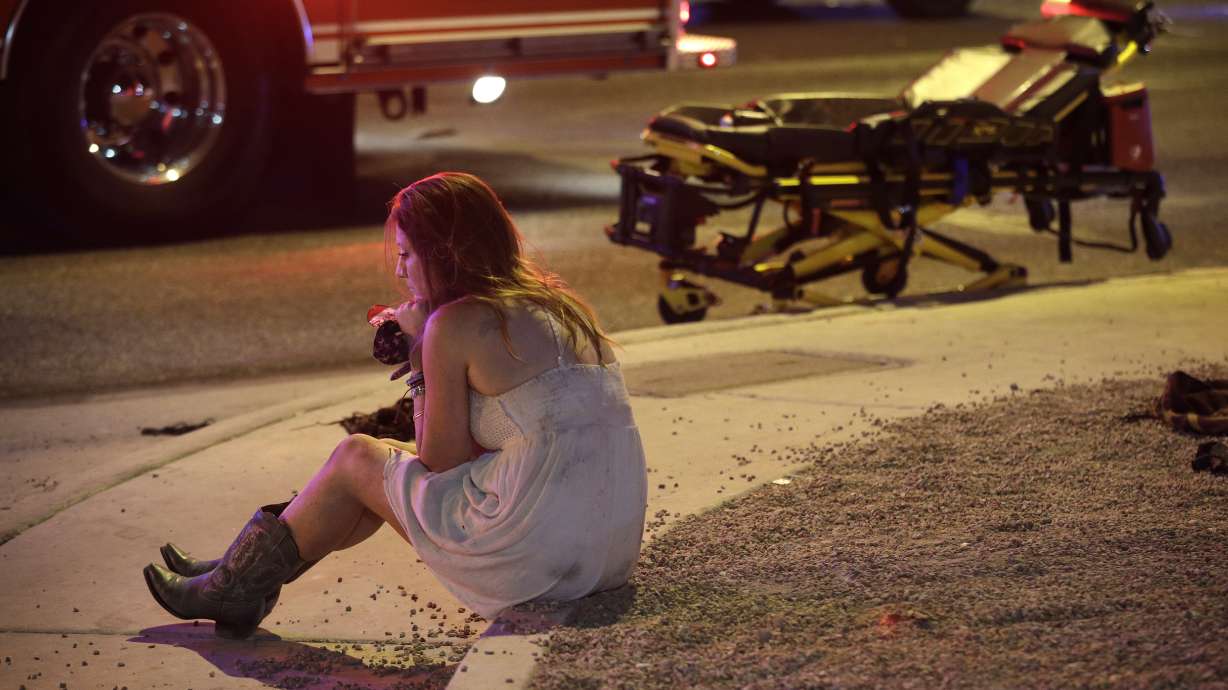 The Latest: Vegas shooting survivors form human chain