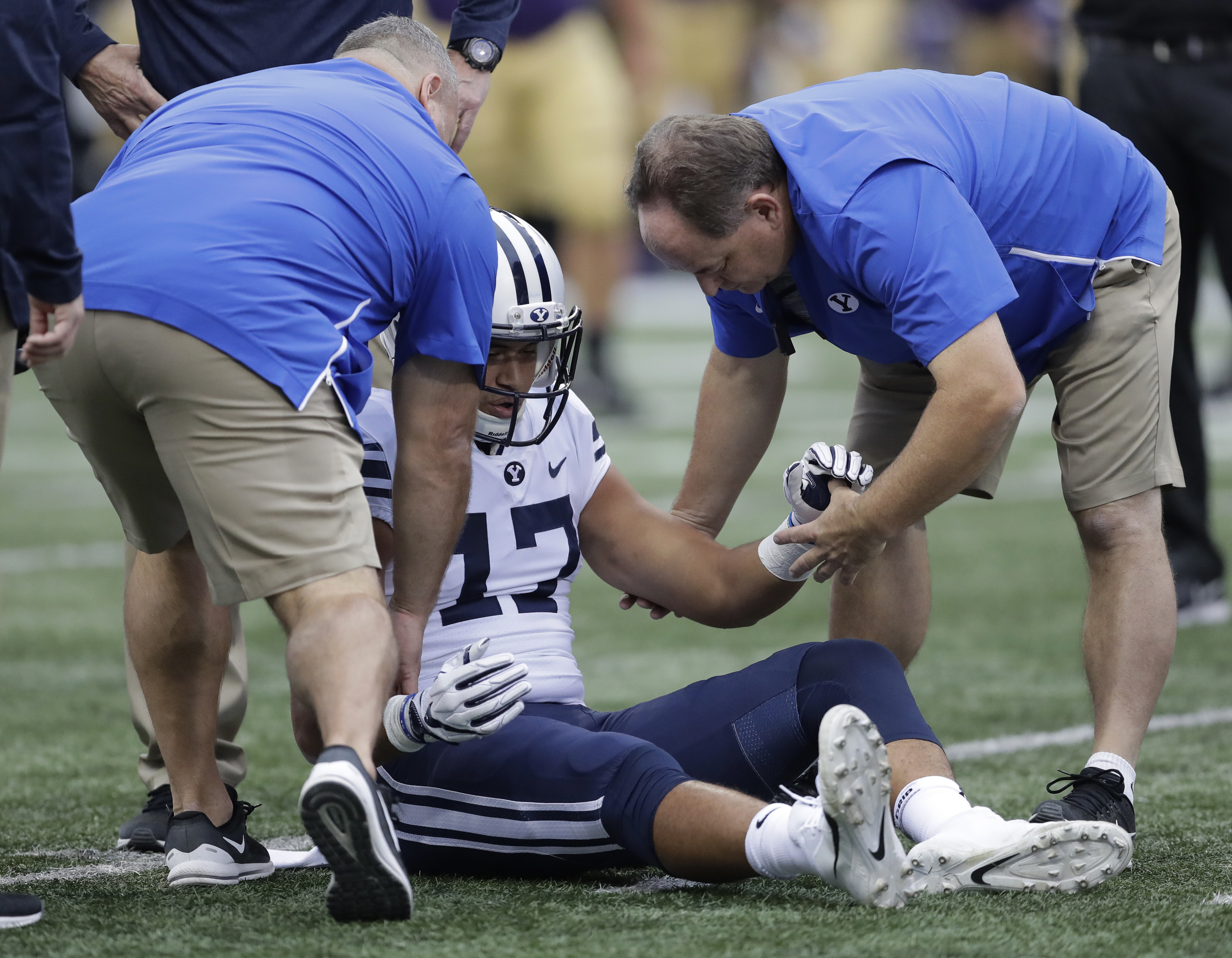 Brigham Young tight end Moroni Laulu-Pututau is helped up after he went down with an injury during the first half of an NCAA college football game against Washington, Saturday, Sept. 29, 2018, in Seattle. (Photo: Ted S. Warren, AP)