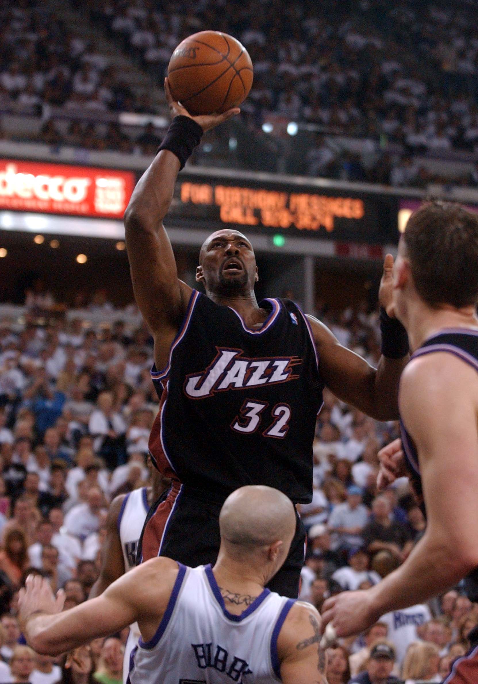 Utah's Karl Malone (32) puts up a shot over Sacramento's Mike Bibby (10) during second-half action as the Jazz face the Kings in game one of the playoffs at Arco Arena in Sacramento Saturday, April 19, 2003. Malone was called for charging on the play. (Photo: Jason Olson, Deseret News)