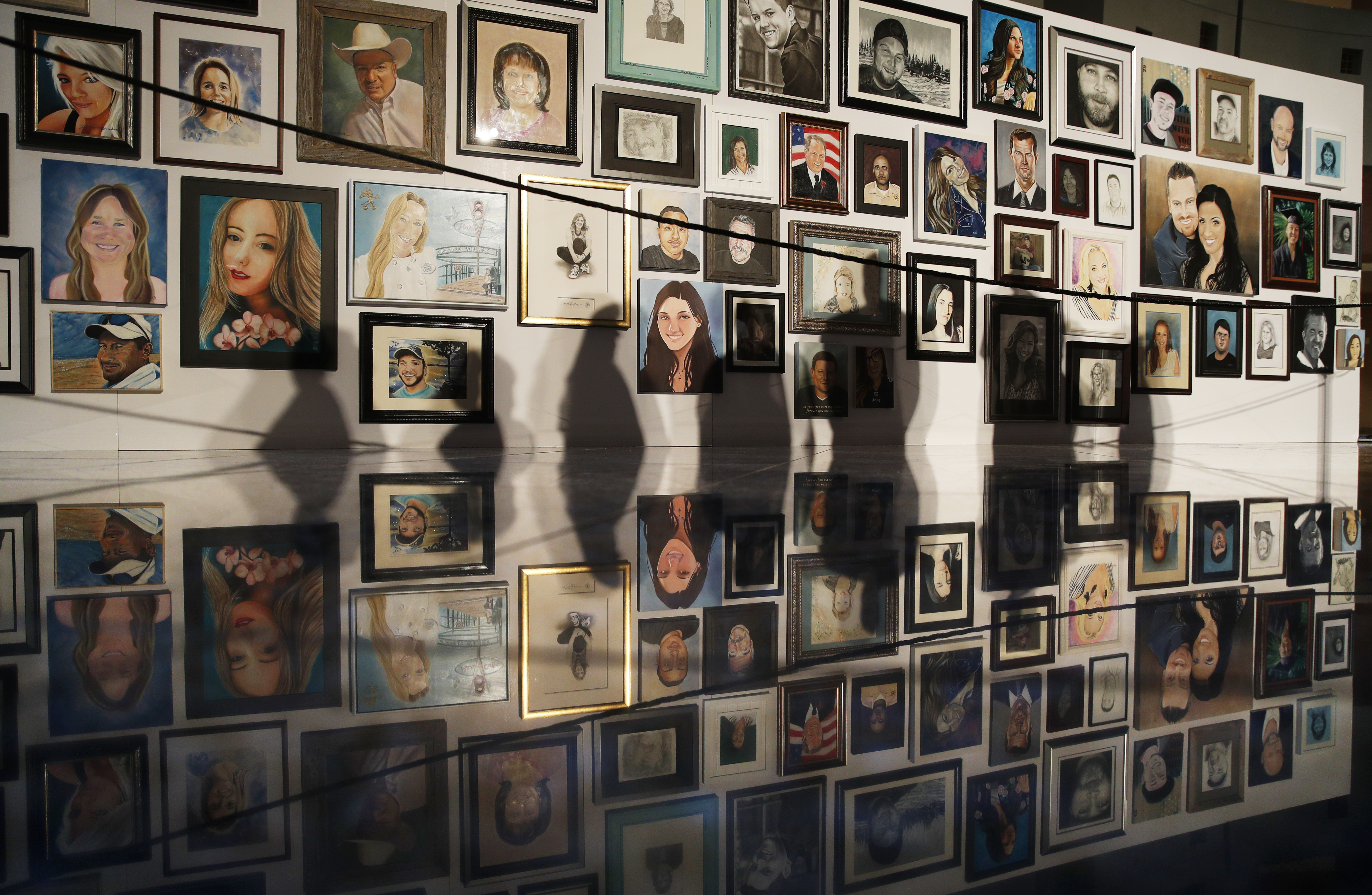 Vegas shooting victims' families view loved ones' portraits