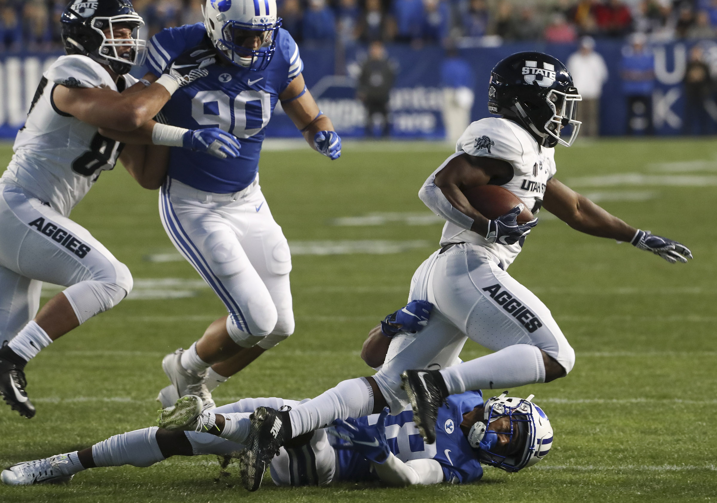 BYU defensive back Michael Shelton (18) makes a sliding tackle on Utah State running back Darwin Thompson (5) during the Utah State versus BYU football game at LaVell Edwards Stadium in Provo on Friday, Oct. 5, 2018. (Photo: Steve Griffin, Deseret News)
