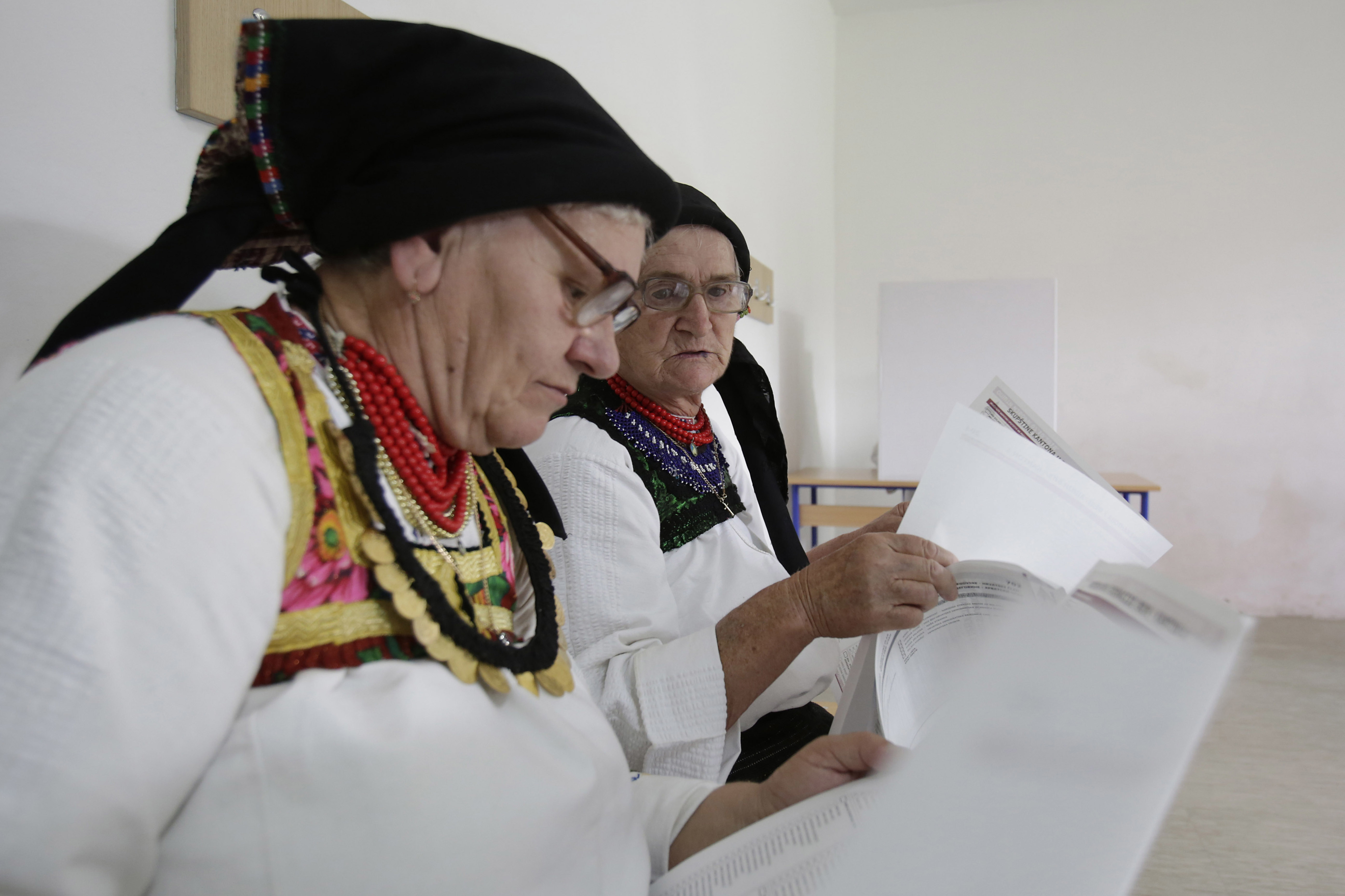 Bosnia village women don folk dresses on election day