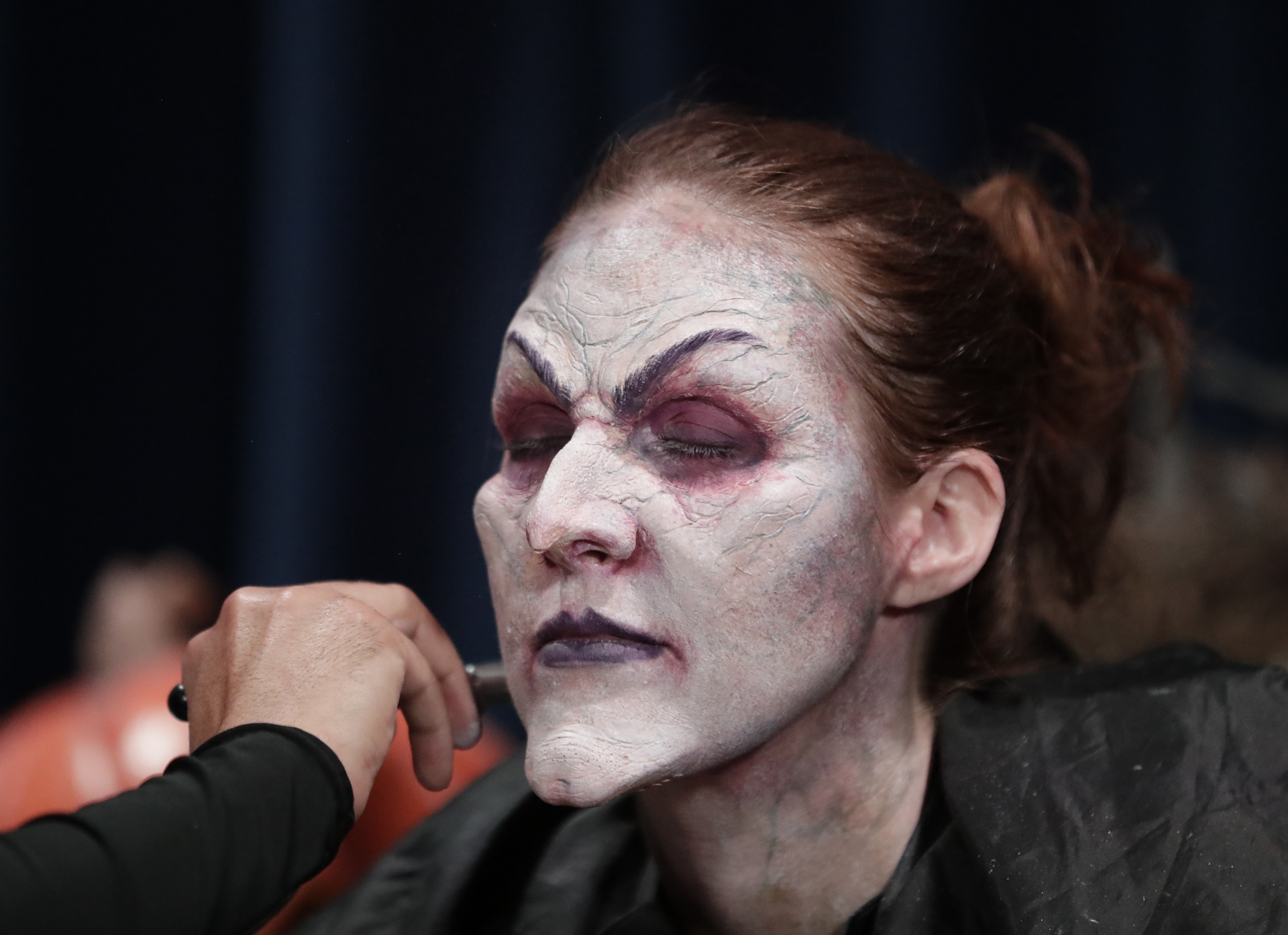 Make-up, wig, cackle. Actress becomes witch at Universal