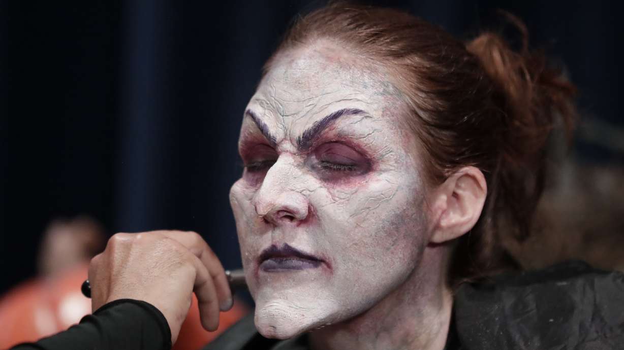 Make-up, wig, cackle. Actress becomes witch at Universal
