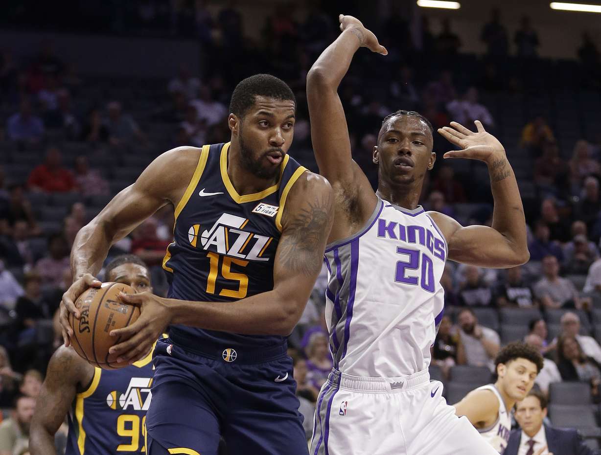 Utah Jazz forward Derrick Favors, left, grabs a rebound next to Sacramento Kings forward Harry Giles III during the first quarter of an NBA preseason basketball game Thursday, Oct. 11, 2018, in Sacramento, Calif. (AP Photo/Rich Pedroncelli)