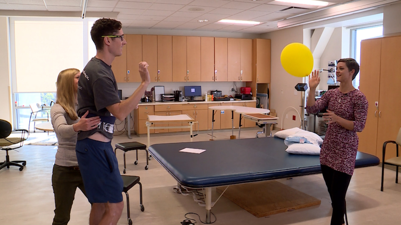 Sarah Child bounces a balloon back and forth with Will Gibbs during a physical therapy appointment. (Photo: KSL TV)