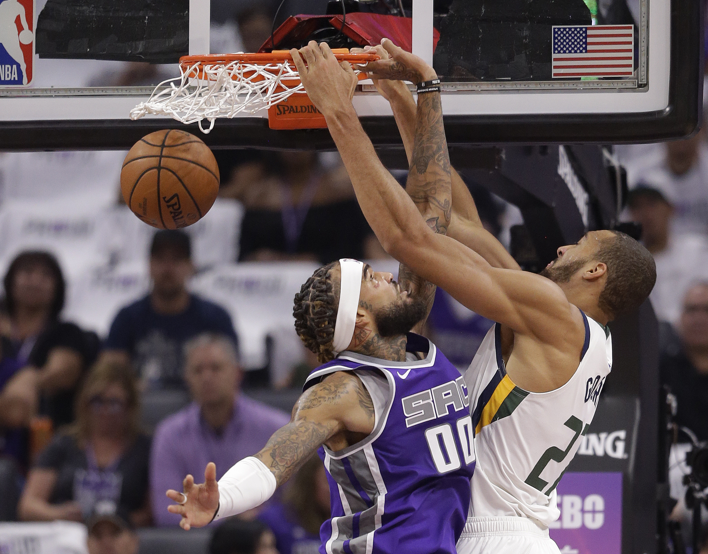Utah Jazz center Rudy Gobert, right, scores over Sacramento Kings center Willie Cauley-Stein during the first quarter of an NBA basketball game Wednesday, Oct. 17, 2018, in Sacramento, Calif. (AP Photo/Rich Pedroncelli)