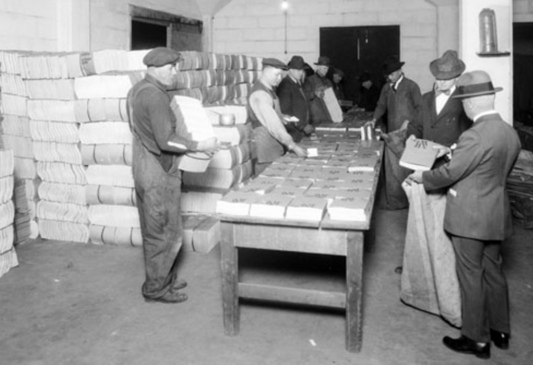 Men load Sears-Roebuck catalogs into bags for delivery in Utah in 1922. (Photo: Utah State History)