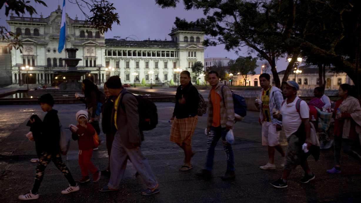 Caravan migrants break Guatemala border fence, rush Mexico