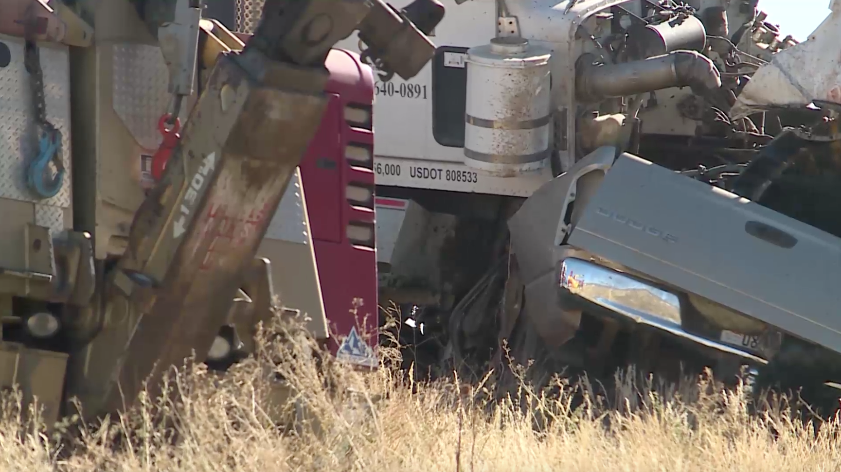 A pickup truck crushed underneath a dump truck after a crash on U.S. Highway 40 Friday. Troopers said at least four people died in the crash. (Photo: KSL TV)