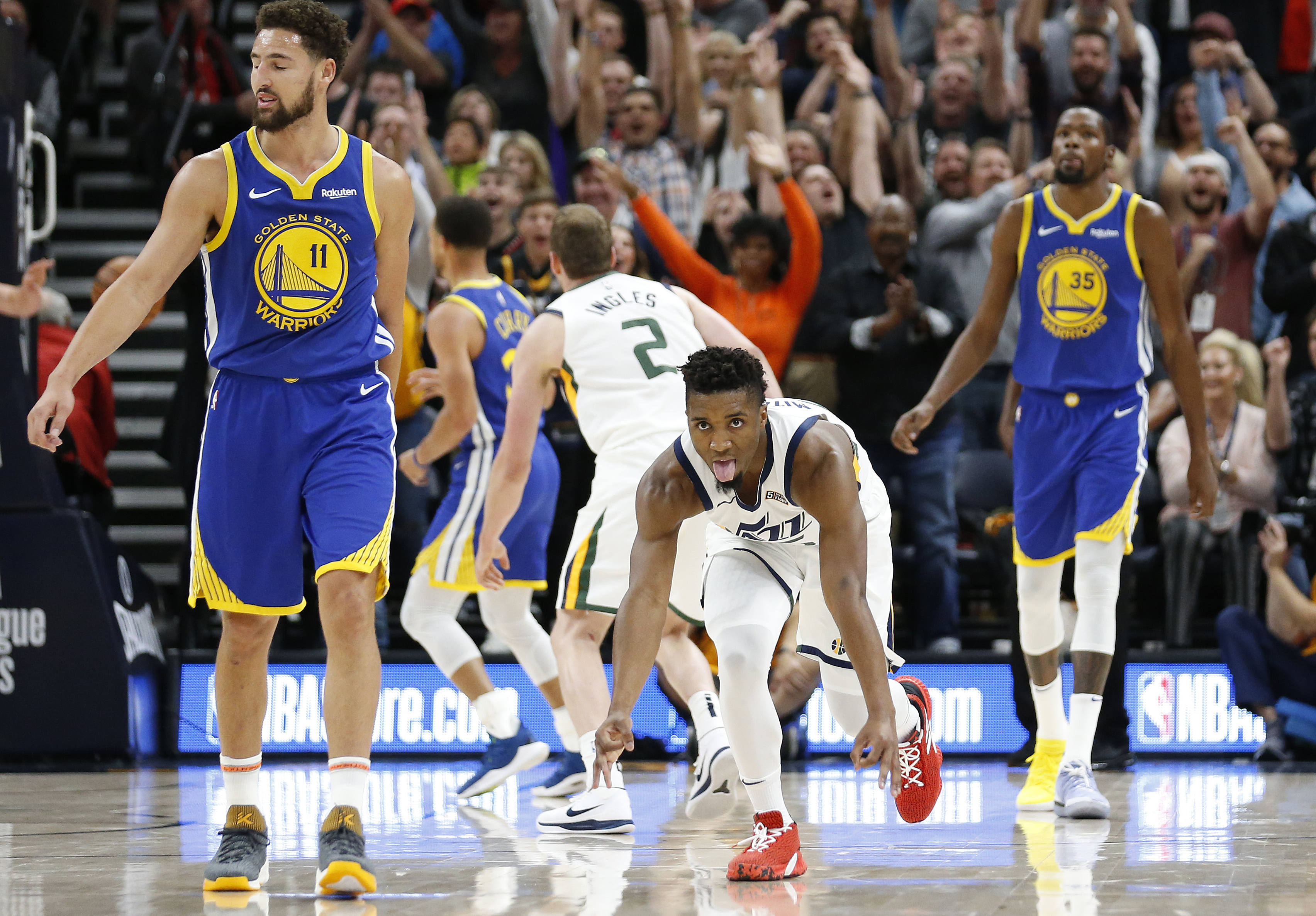 Utah Jazz guard Donovan Mitchell, center, celebrates his 3-pointer as Golden State Warriors' Klay Thompson (11) and Kevin Durant (35) walk up court in the first half during an NBA basketball game Friday, Oct. 19, 2018, in Salt Lake City. (Photo: Rick Bowmer, AP)