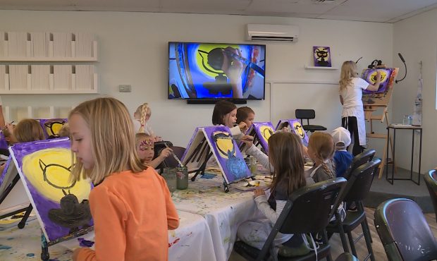A TV screen at the front of the room lets kids see how Cami Payne is painting her cat Tuesday, Oct. 16, 2018. Photo: Ray Boone, KSL TV