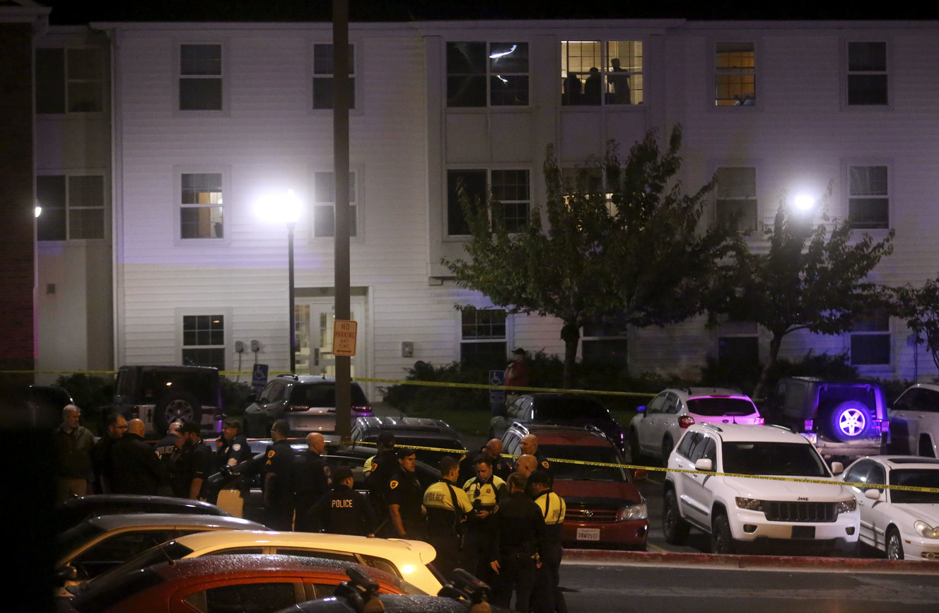 People watch from a window as police gather on the University of Utah campus to search for a shooting suspect in Salt Lake City on Monday, Oct. 22, 2018. (Photo: Kristin Murphy, KSL)