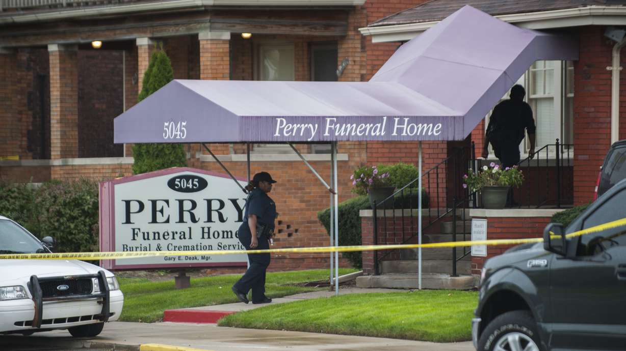 The Latest: Cremains given police escort to funeral home