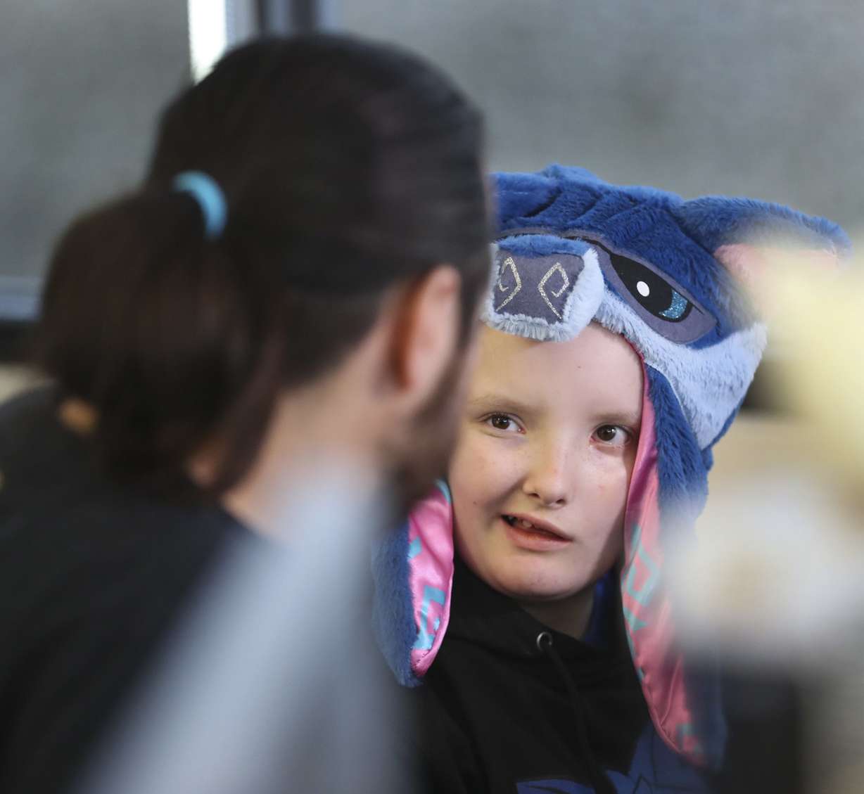 Taylor Maw, WildWorks' lead character artist, chats with Meagyn Moeller, 12, who is wearing a wolf hat based on a character from WildWorks' online game “Animal Jam,” at the company's offices in Draper on Thursday, Oct. 25, 2018. (Photo: Steve Griffin, KSL)