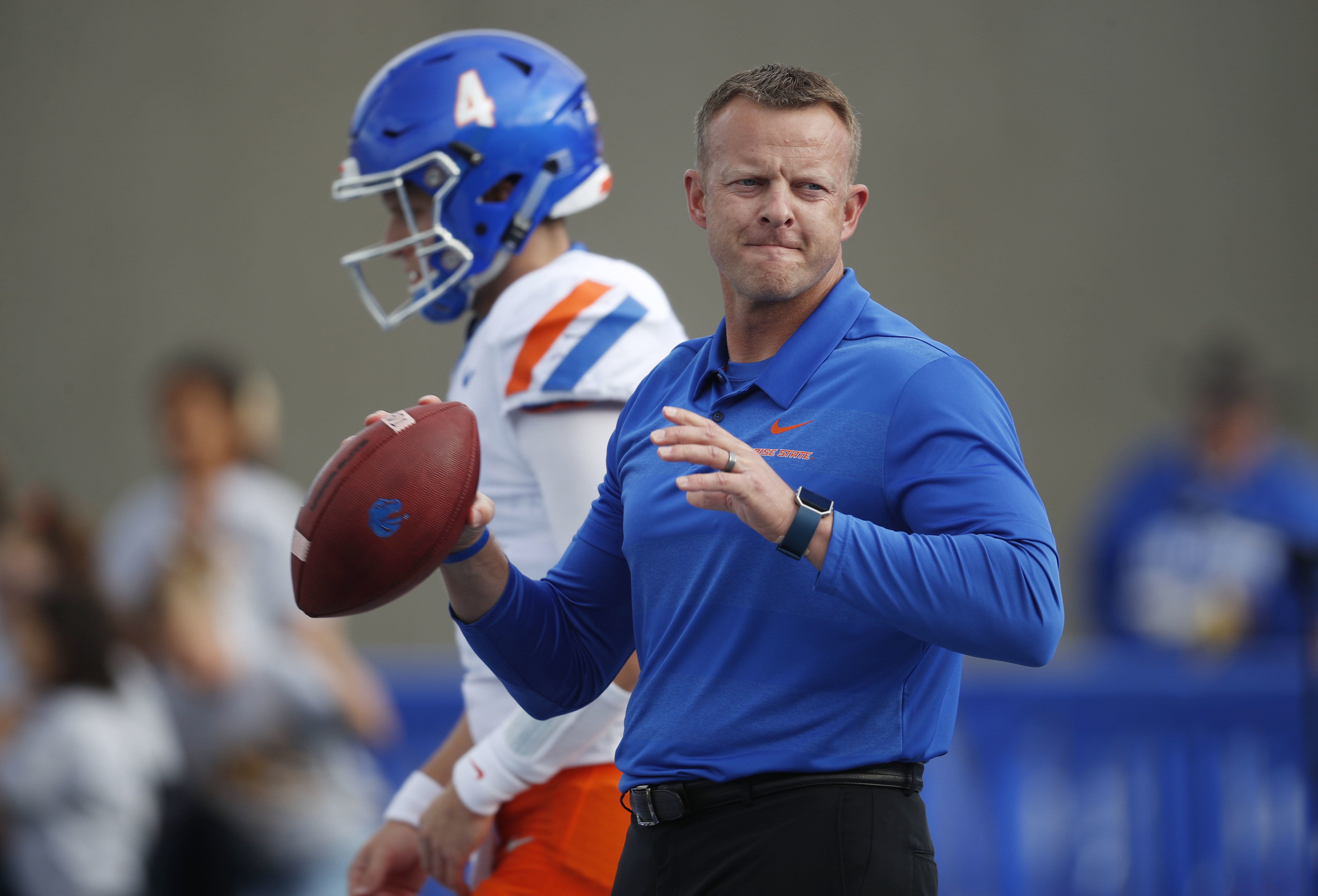 Boise State head coach Bryan Harsin throws passes to receivers along with quarterback Brett Rypien, back, before the first half of an NCAA college football game against Air Force Saturday, Oct. 27, 2018, at Air Force Academy, Colo. (Photo: David Zalubowski, AP Photo)
