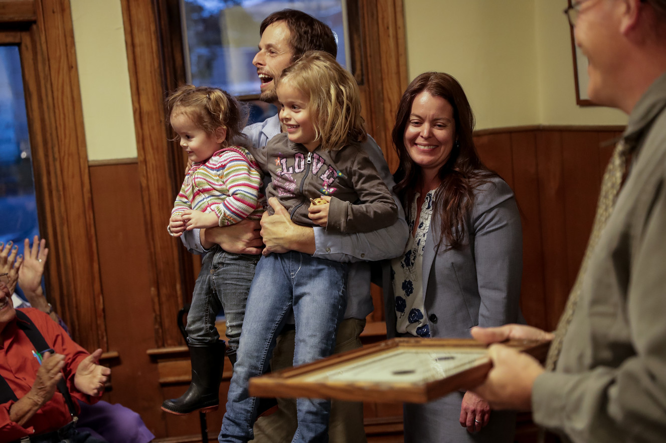 Bill Tibbitts, associate director of the Crossroads Urban Center, his wife, Jana, and their daughters, Samantha, 2, and Cassidy, 5, accept the first Tibbitts Award for Outstanding Young Volunteer on behalf of their late son, Oliver Tibbitts, for whom the award is named, at the center in Salt Lake City on Thursday, Oct. 25, 2018. (Photo: Spenser Heaps, KSL)