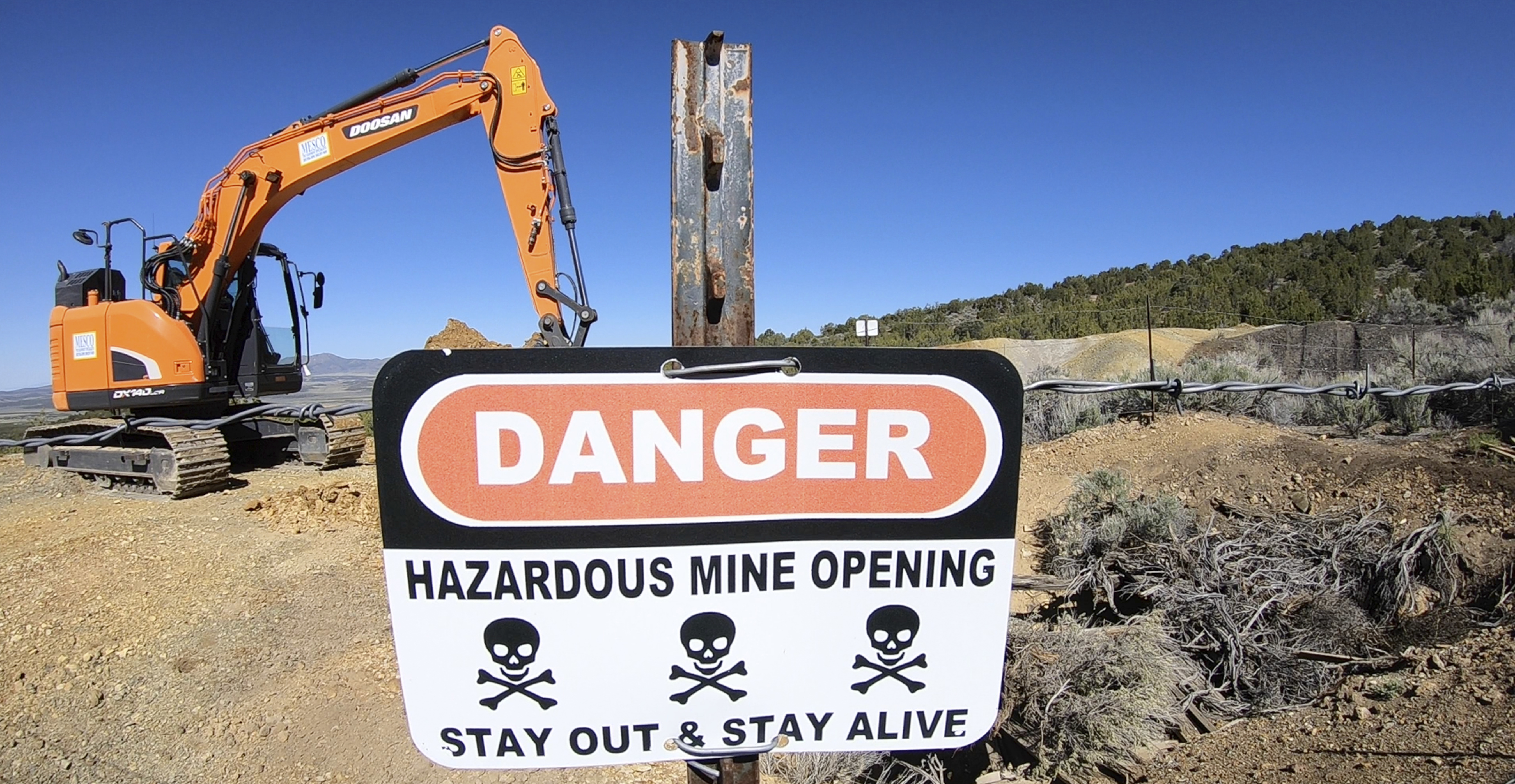 In this May 16, 2018, photo, a mine shaft is covered near Eureka, Utah. In Utah alone, the state is trying to seal more than 10,000 open mines with cinderblocks and metal grates after people have died in rock falls and all-terrain-vehicle crashes and from poisonous air over the past three decades. For the state, the message is as clear as its skull-and-crossbones signs: Stay out and stay alive. The program has been around more than 30 years, and the division has sealed some 6,000 abandoned mines. (AP Photo/Rick Bowmer)