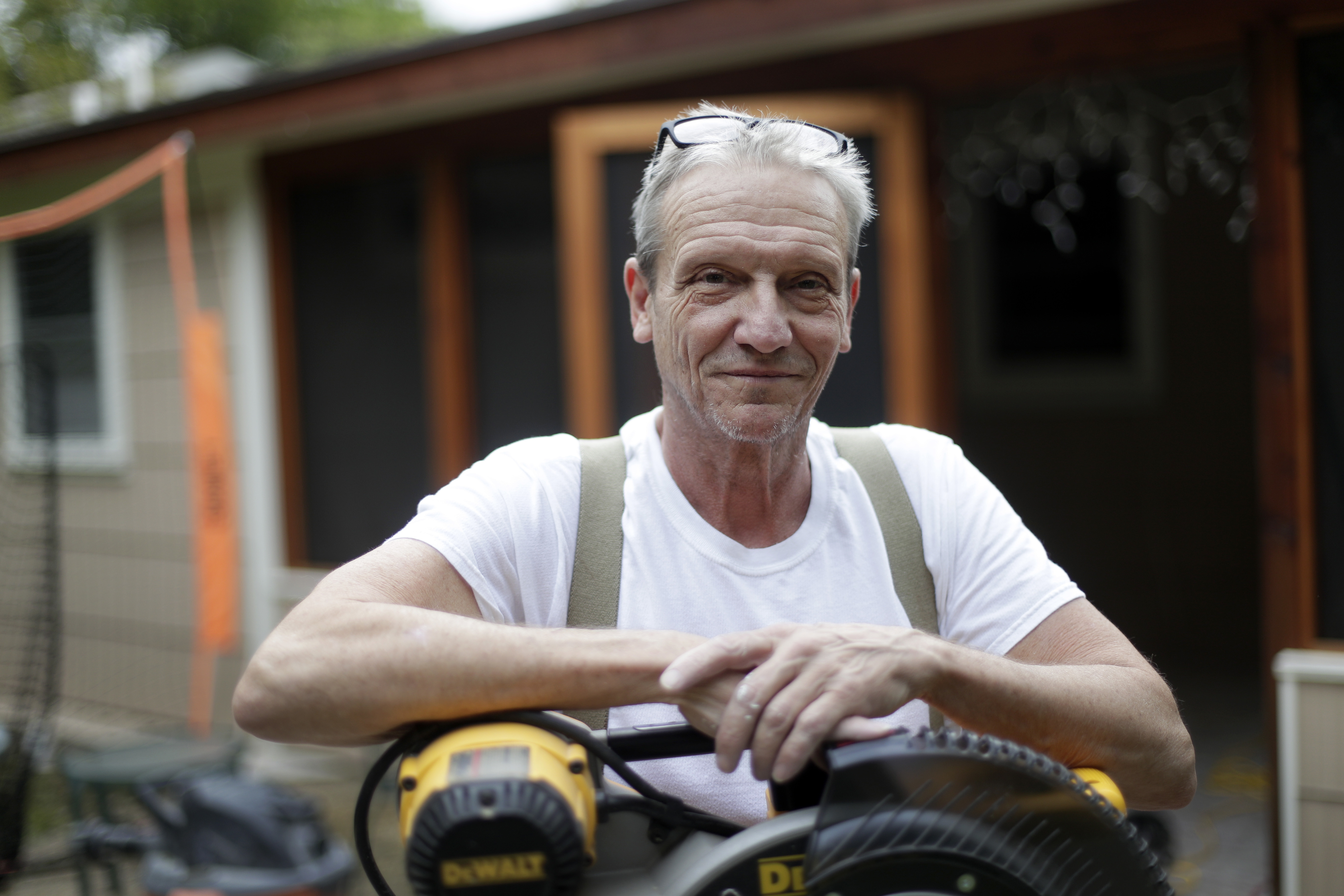 Contractor Mike Hewitt poses for a photo at a job site in Austin, Texas, Tuesday, Oct. 30, 2018. Hewitt, a self-employed home remodeling contractor covered by Obamacare who is planning to renew, fell off a roof a few years ago and he says he was lucky that he was covered by the ACA because it allowed him to get treatment for a shattered heel and torn arm muscles. (AP Photo/Eric Gay)