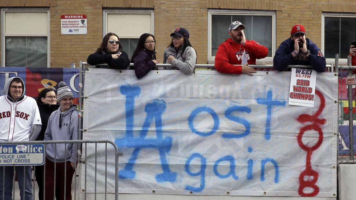 The Latest: Sox manager, trophy hit by beer cans at parade