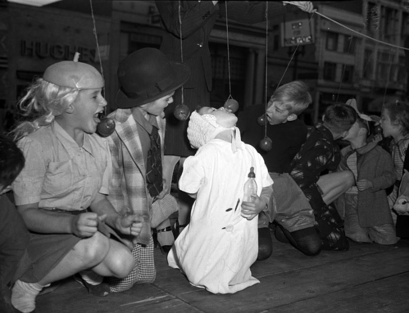 Children eat apples off a string at a Utah Halloween party on Oct. 28, 1945. (Photo: Utah State History)