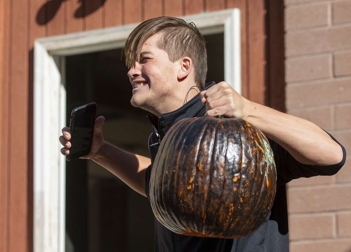 Cameron Gaudin celebrates his pumpkin's survival during a pumpkin catch at the City Academy in Salt Lake City on Monday, Nov. 5, 2018. (Photo: Scott G Winterton, KSL)
