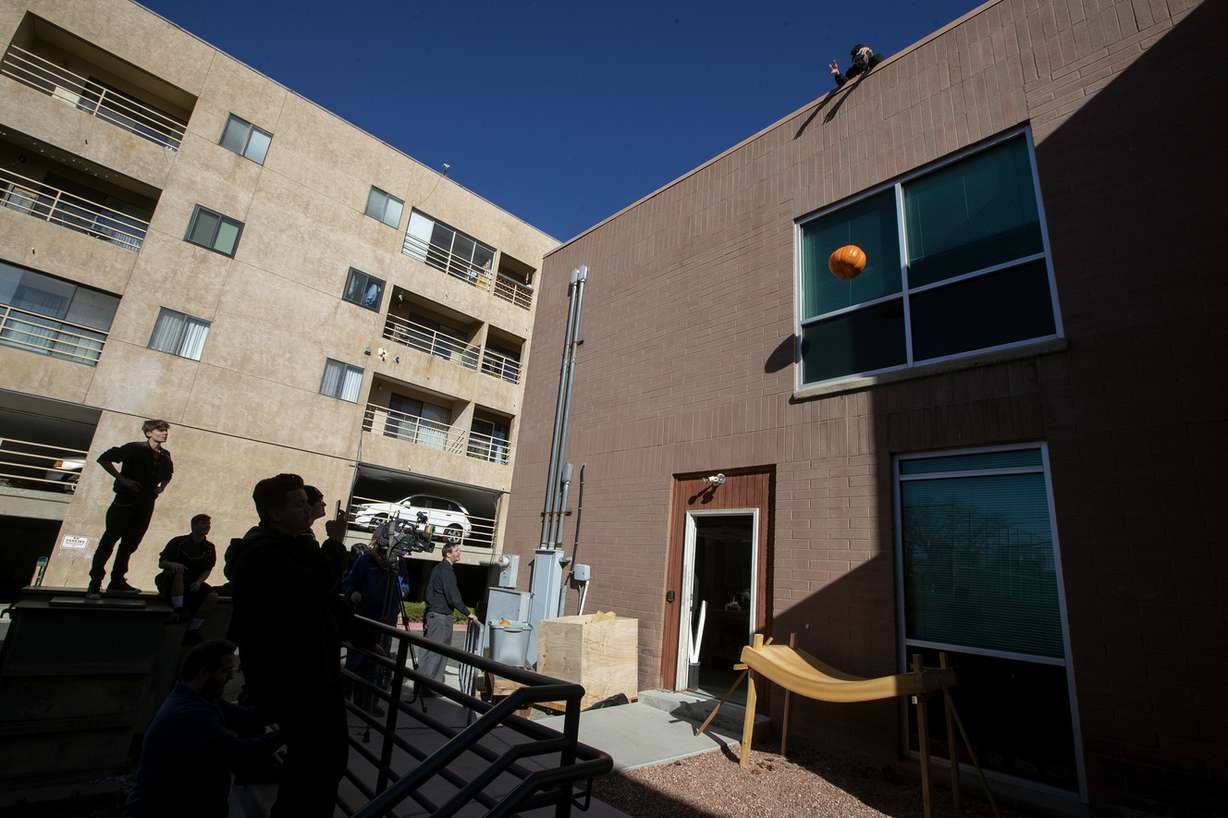Physics students at the City Academy in Salt Lake City watch as a pumpkin is dropped from a roof during a pumpkin catch on Monday, Nov. 5, 2018. (Photo: Scott G Winterton, KSL)