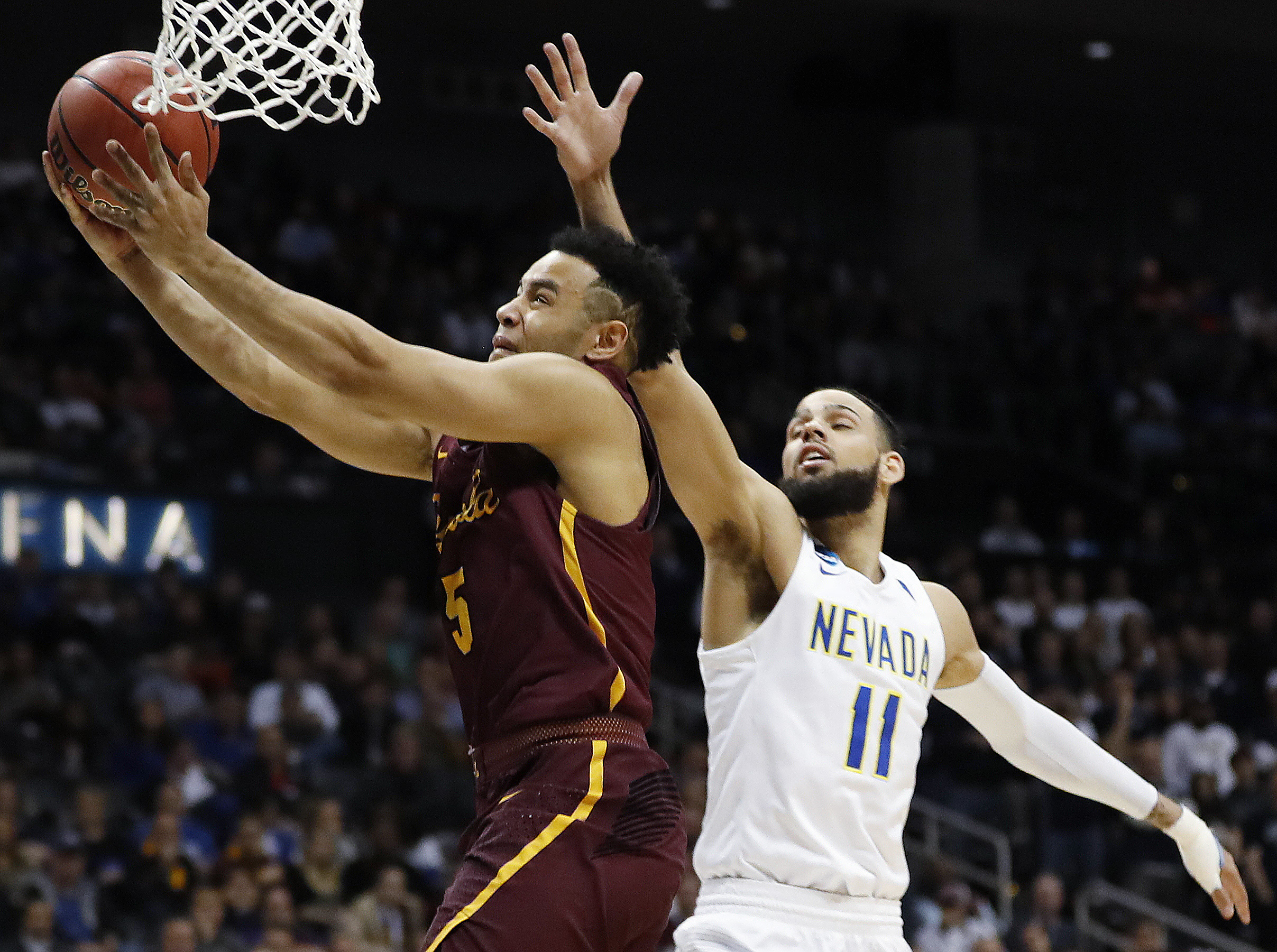 Loyola-Chicago guard Marques Townes (5) moves to the hoop as Nevada forward Cody Martin (11) defends during the second half of a regional semifinal NCAA college basketball game, Thursday, March 22, 2018, in Atlanta. (Photo: David Goldman, AP Photo)