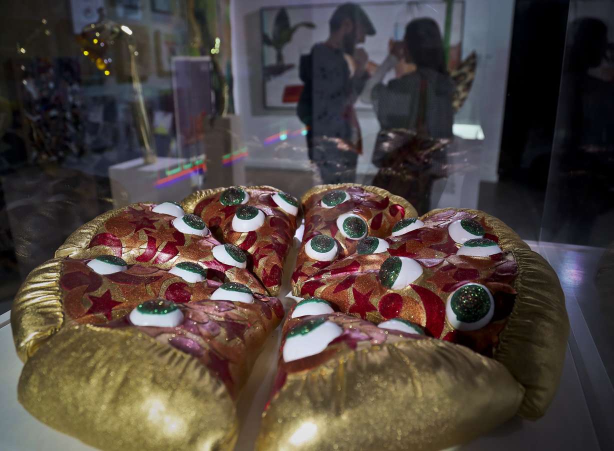 This Nov. 2, 2018 photo shows a textile sculpture from artist Hein Koh called "Mystic Pizza," part of a group art exhibition celebrating pizza at The Museum of Pizza in New York. (AP Photo/Bebeto Matthews)