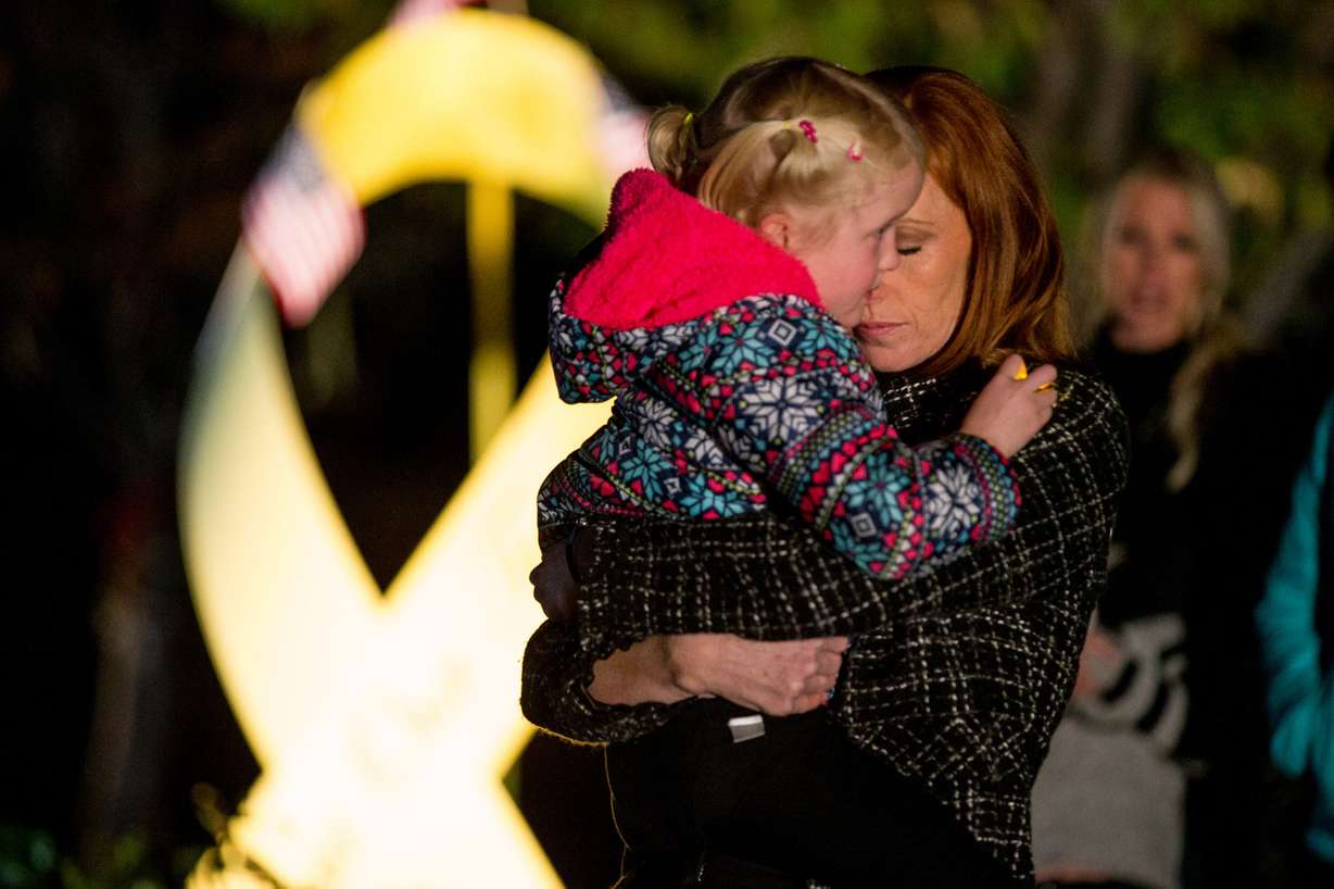 Jennie Taylor holds her daughter while speaking to those gathered for a vigil honoring her late husband, Maj. Brent Taylor, outside their home in North Ogden on Wednesday, Nov. 7, 2018. Taylor, mayor of North Ogden and a major in the Utah Army National Guard, was killed in Afghanistan on Saturday. (Photo: Spenser Heaps, KSL)