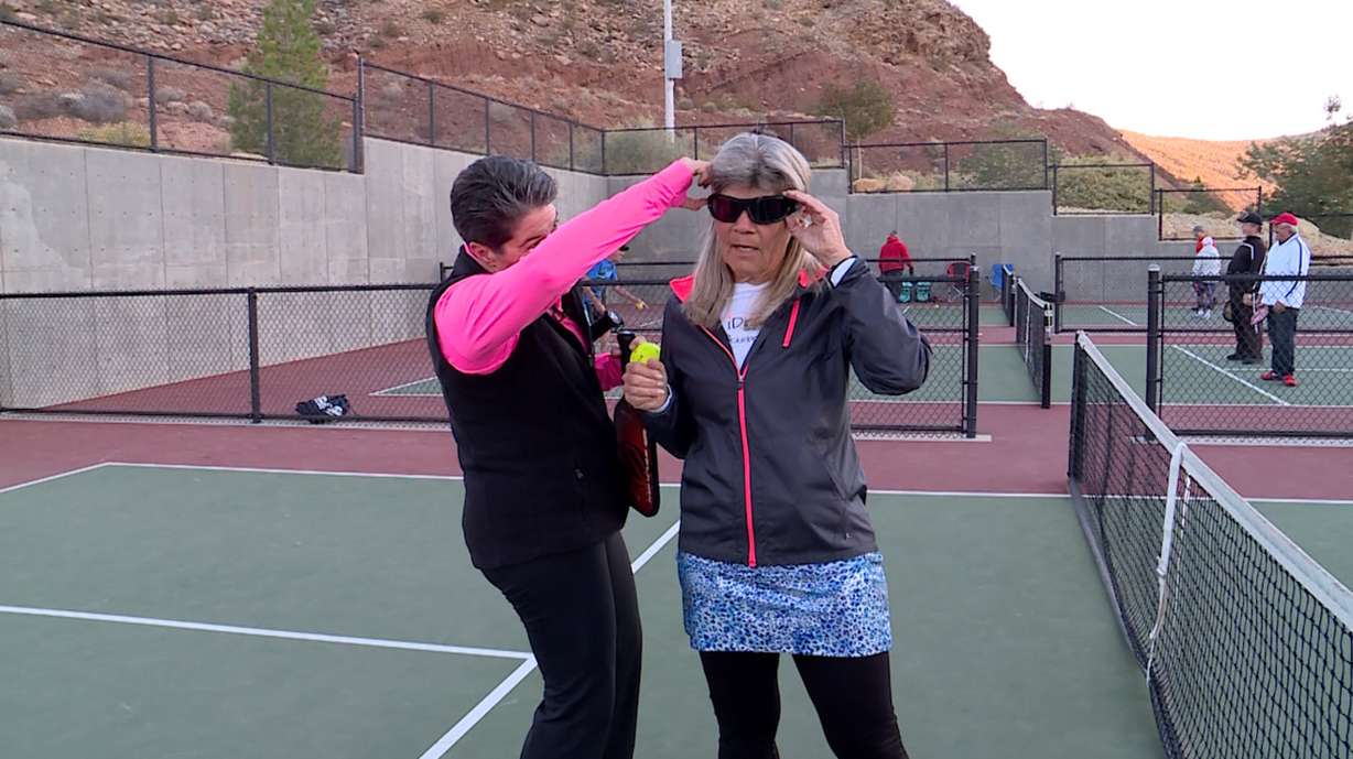 Julie Kanouse tries on strobe training glasses for the first time. (Photo: KSL TV)
