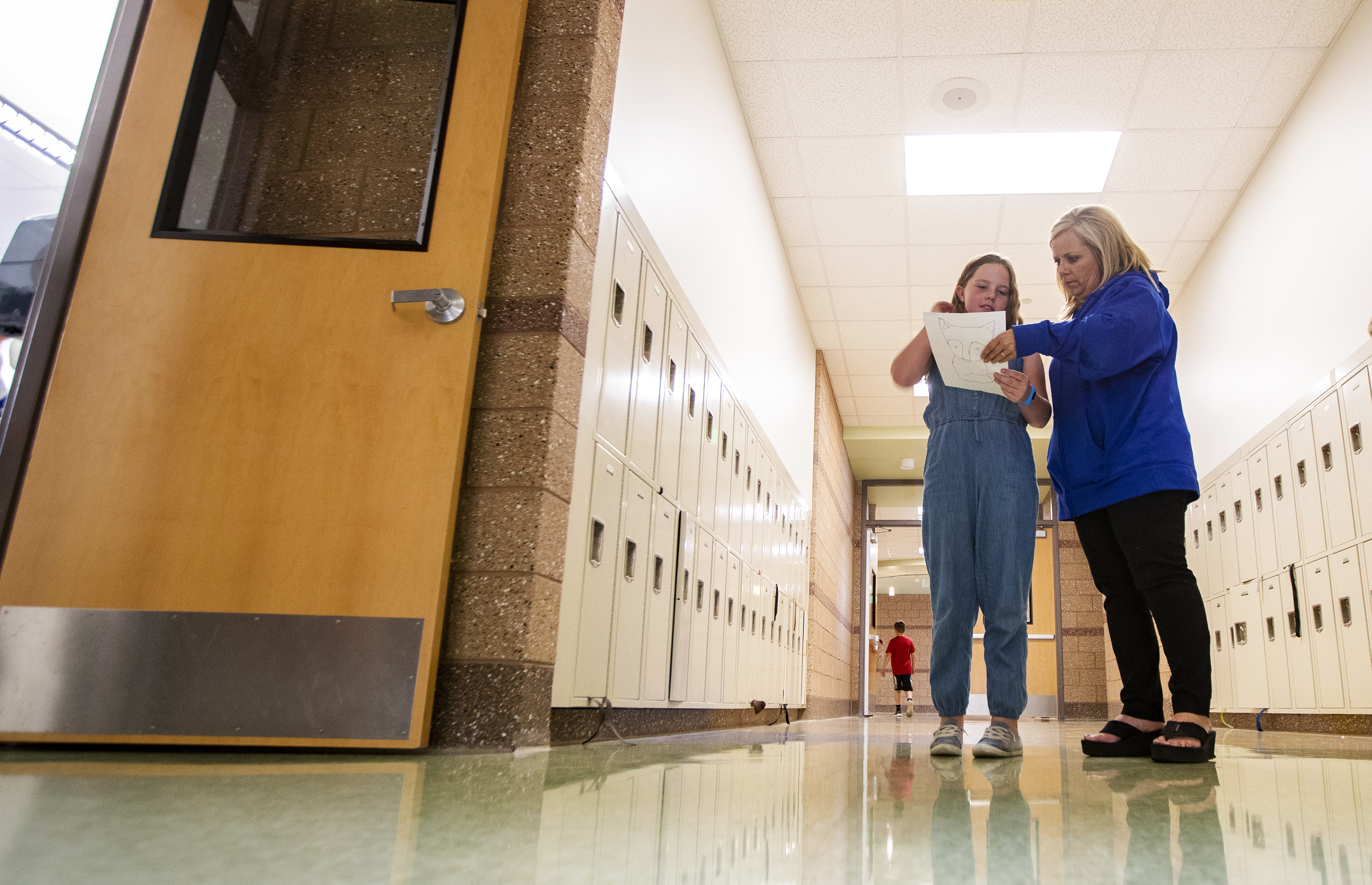 In this Oct. 29, 2018 photo, Lizzie Robinson talks with Tess Jensen a 5th grade teacher at Beaver School District's Belknap Elementary School in Beaver, Utah. Belknap is one of the highest performing elementary schools in Utah and is a Title 1 school. (Scott G Winterton/The Deseret News via AP)