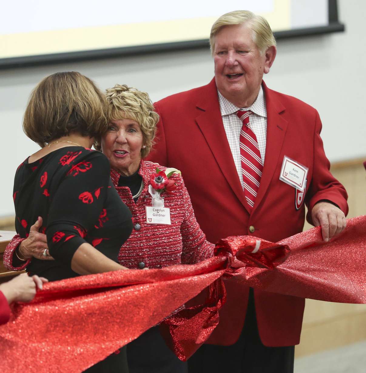 University of Utah president Ruth Watkins hugs Carolyn Gardner, center, as Gardner and her husband, Kem, right, attend a dedication and celebration of the new Carolyn and Kem Gardner Commons building on the University of Utah campus in Salt Lake City on Friday, Nov. 9, 2018. (Photo: Steve Griffin, KSL)