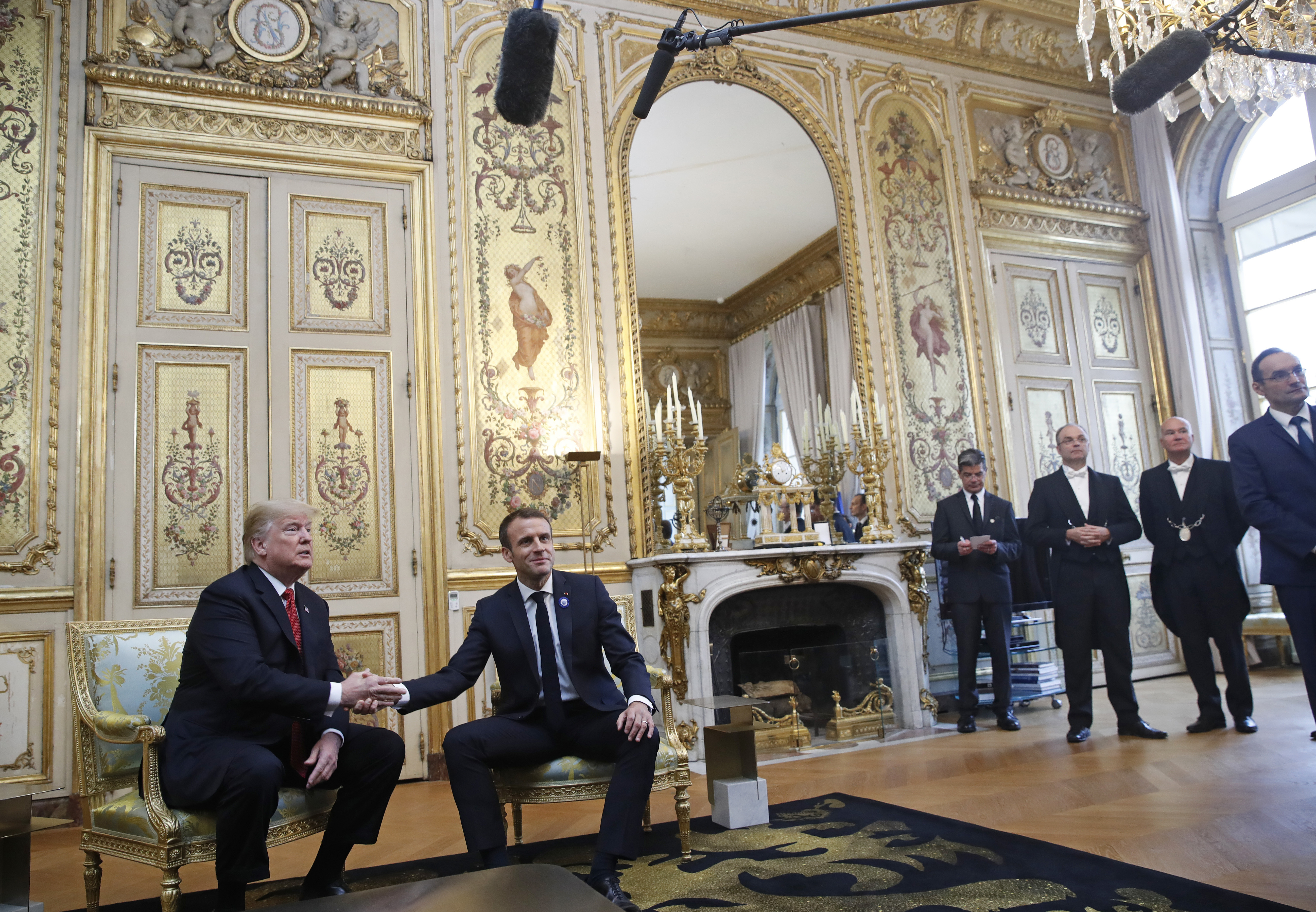 Tapping Trump's thigh, Macron seeks to defuse tensions