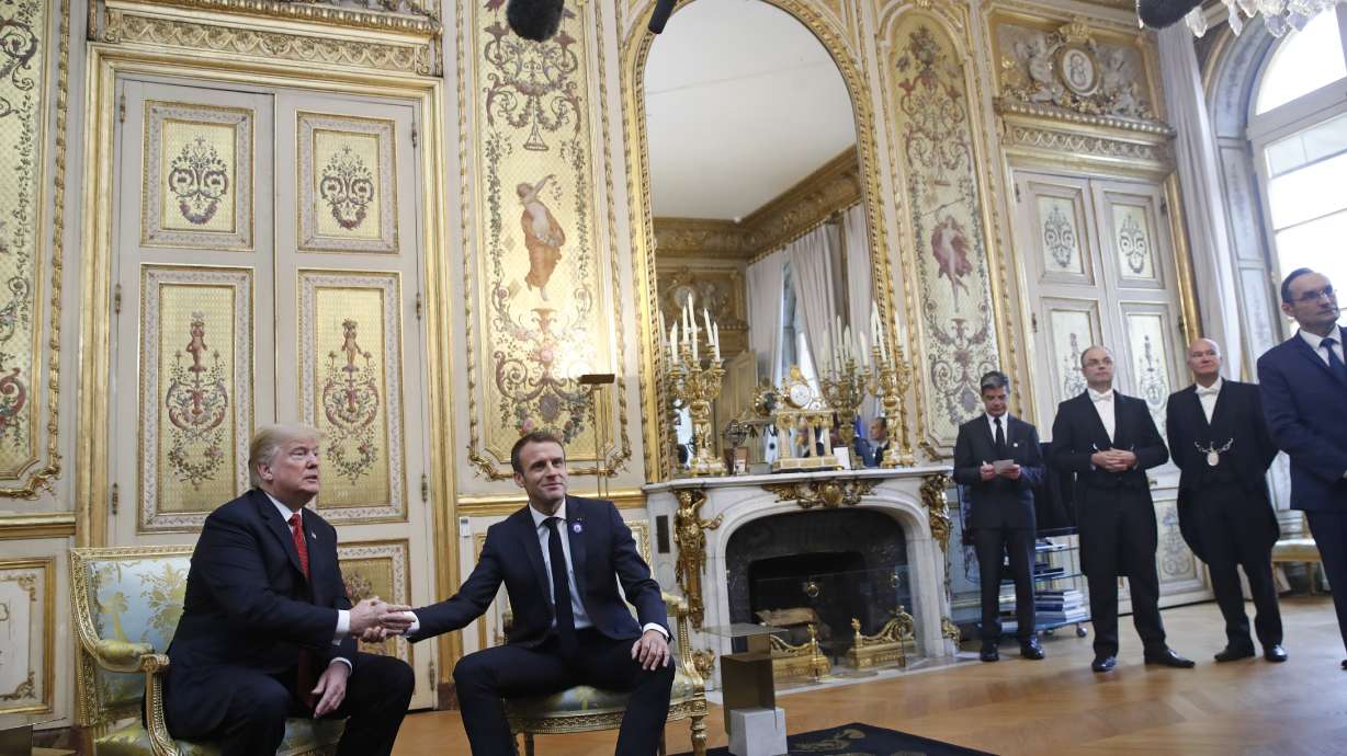 Tapping Trump's thigh, Macron seeks to defuse tensions