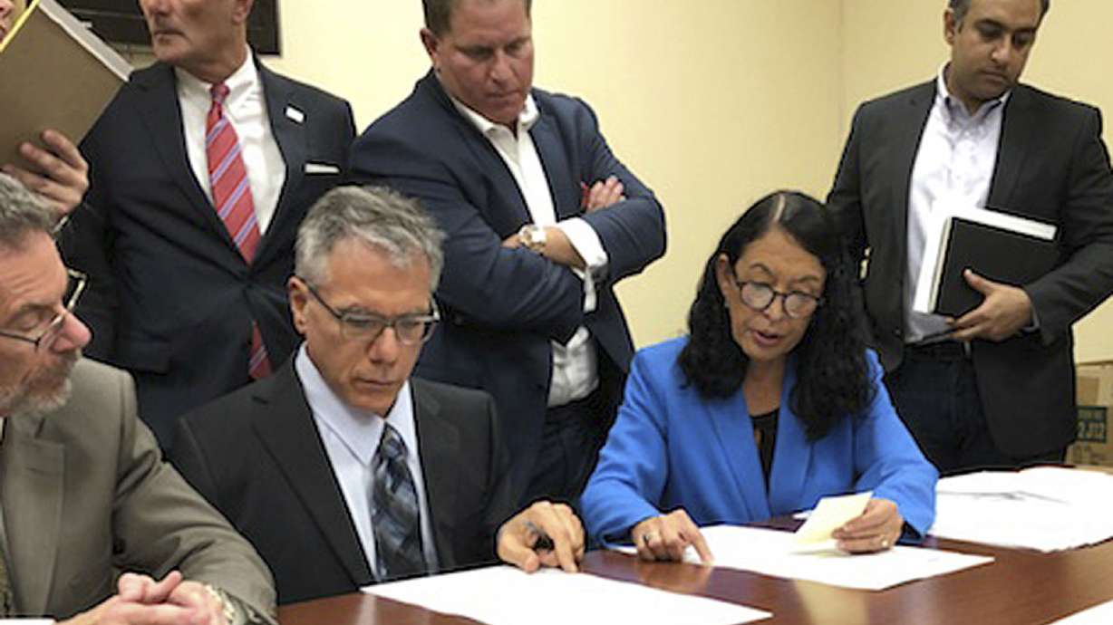 The Latest: Florida counties begin recounting ballots