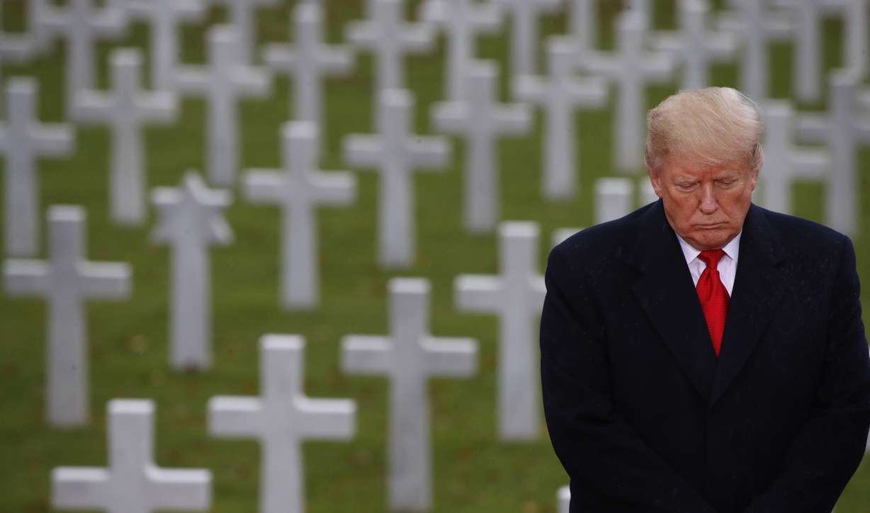 President Donald Trump stands in front of headstones during an American Commemoration Ceremony, Sunday Nov. 11, 2018, at Suresnes American Cemetery near Paris. Trump is attending centennial commemorations in Paris this weekend to mark the Armistice that ended World War I. (AP Photo/Jacquelyn Martin)