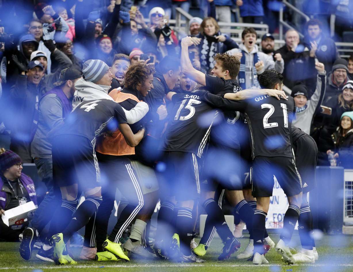 Players for Sporting Kansas City celebrate their 4-2 win over Real Salt Lake at the end of a MLS Western Conference semifinals soccer match in Kansas City, Kan., Sunday, Nov. 11, 2018. (Photo: Colin E. Braley, AP)