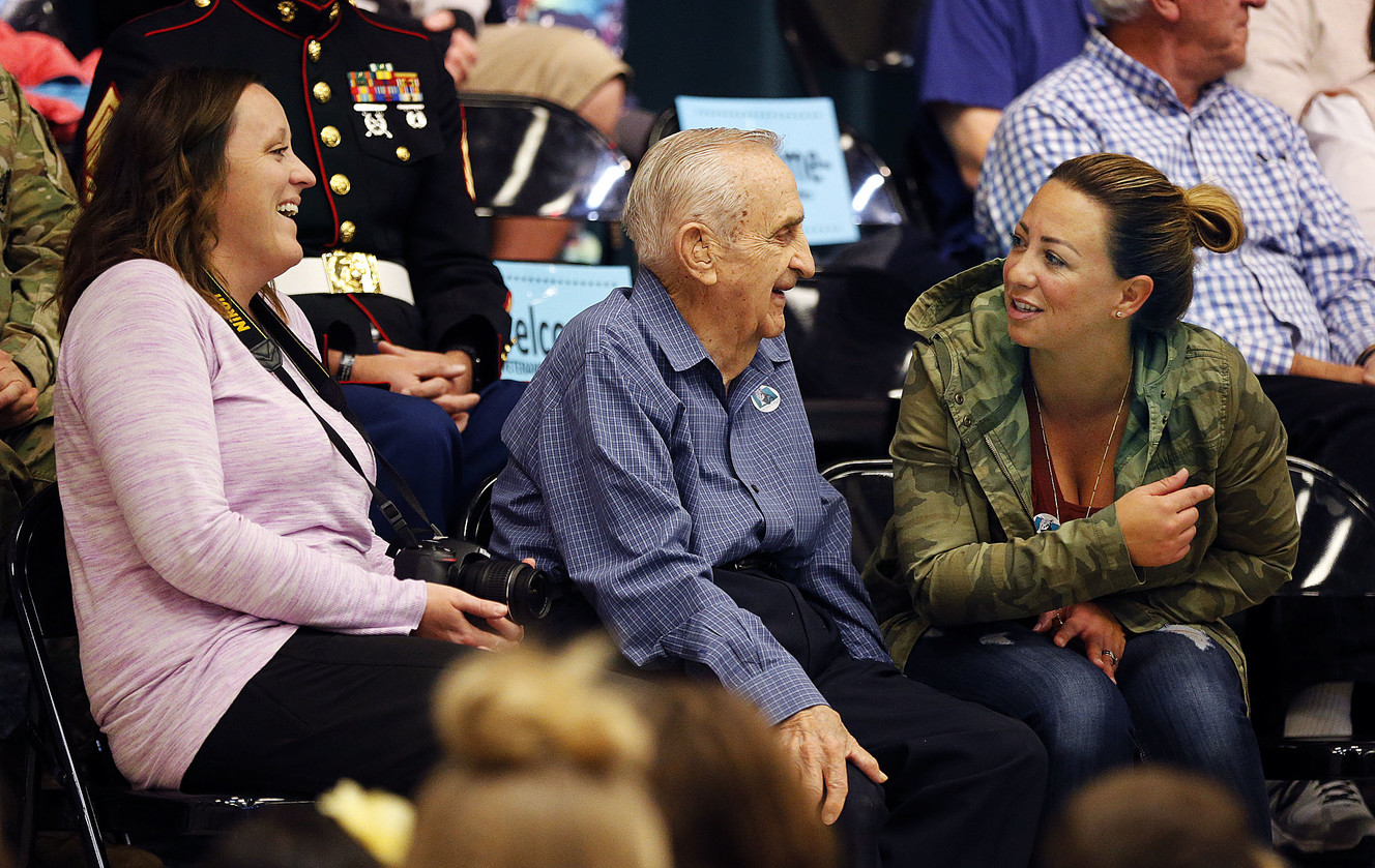 World War II Navy veteran Harold Smith smiles with his granddaughters Cassidie Fenton, left, and Kira Rhodes during an assembly honoring veterans at Midas Creek Elementary in Riverton on Monday, Nov. 12, 2018. (Photo: Ravell Call, KSL)
