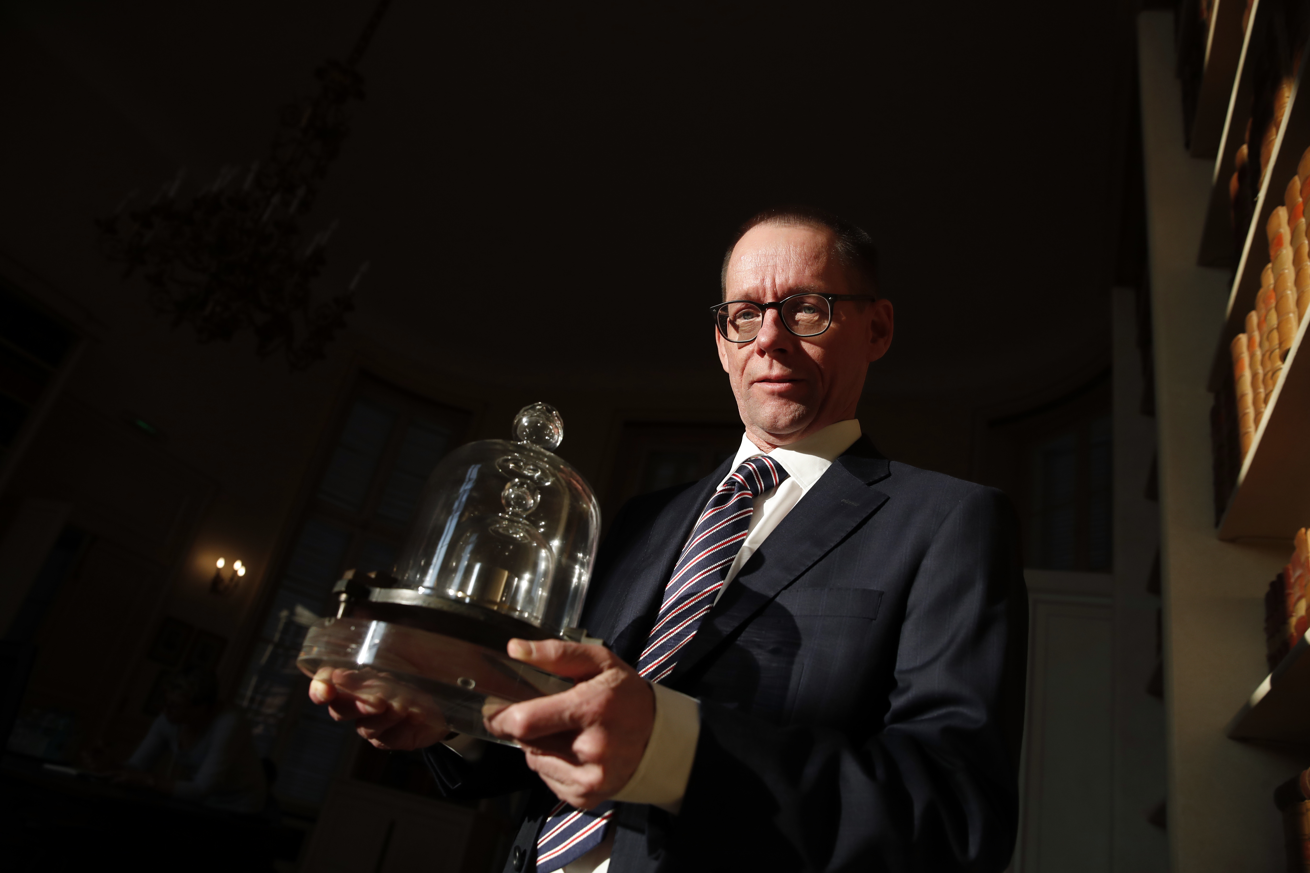 In this photo taken Wednesday, Oct. 17, 2018., the head of BIPM (International Bureau of Weights and Measures) Martin J.T. Milton holds a replica of the International Prototype Kilogram in Sevres, near Paris. Photo: AP Photo