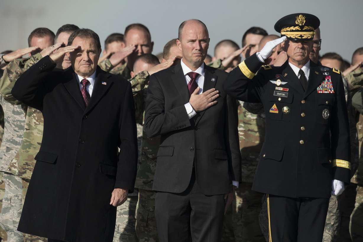 Gov. Gary Herbert, left, Lt. Gov. Spencer J. Cox, and Maj. Gen. Jefferson S. Burton, adjutant general of the Utah National Guard, salute as members of the Guard's honor guard detail carry Maj. Brent R. Taylor's casket at Roland R. Wright Air National Guard Base in Salt Lake City on Wednesday, Nov. 14, 2018. Taylor, 39, of North Ogden, died Nov. 3, 2018, in Afghanistan of wounds sustained from small arms fire. His funeral is scheduled for Saturday, Nov. 17, in Ogden. (Photo: Matt Herp)