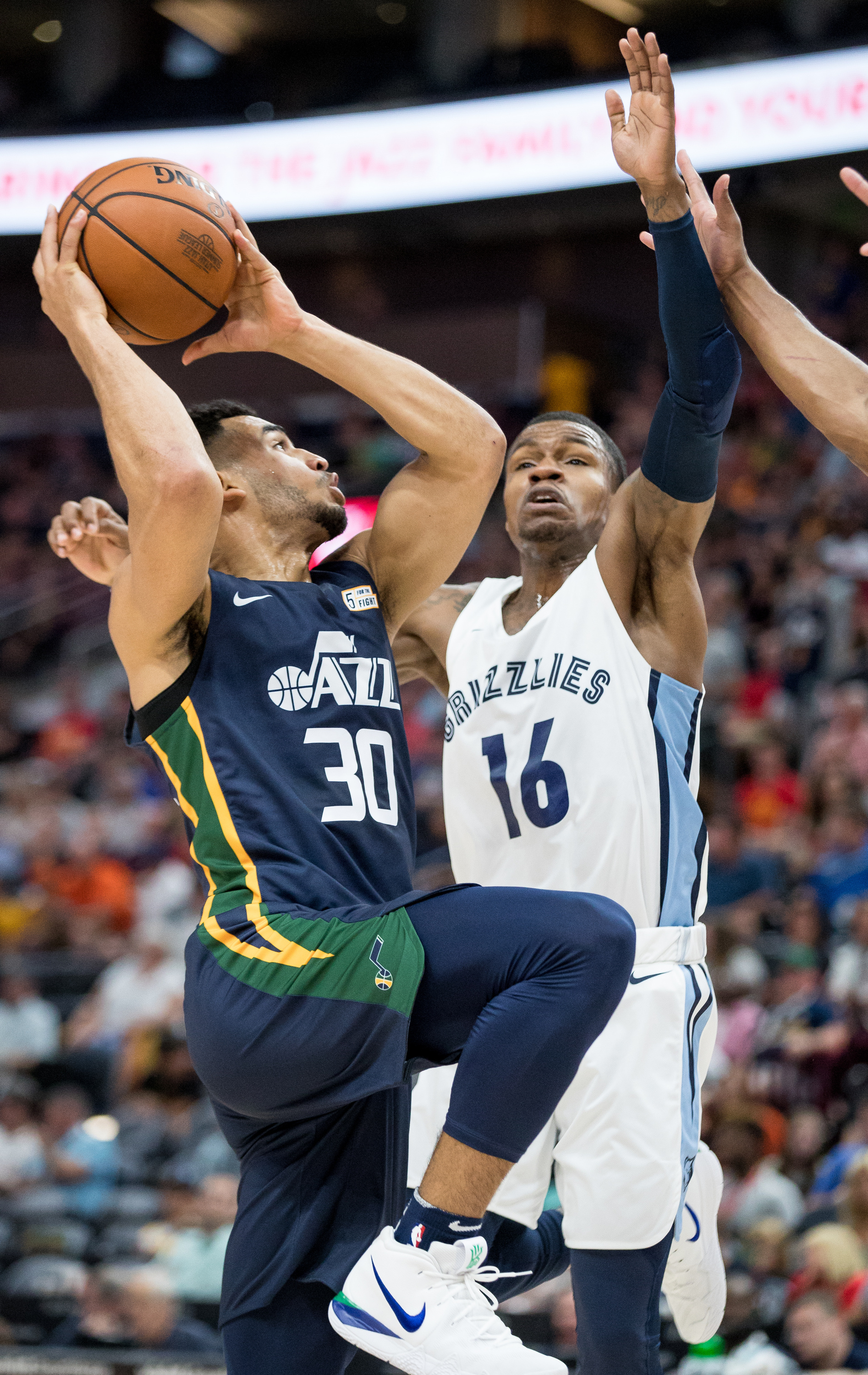The Utah Jazz's Naz Mitrou-Long drives to the hoop against the Memphis Grizzlies' Brandon Goodwin during a Summer League game at Vivint Smart Home Arena in Salt Lake City on Tuesday, July 3, 2018.
