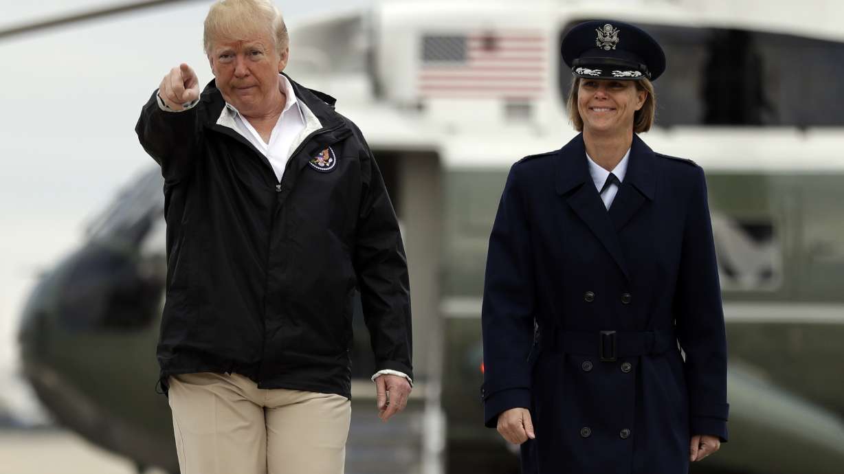 Trump sees wildfire areas, consoles those harmed by shooting