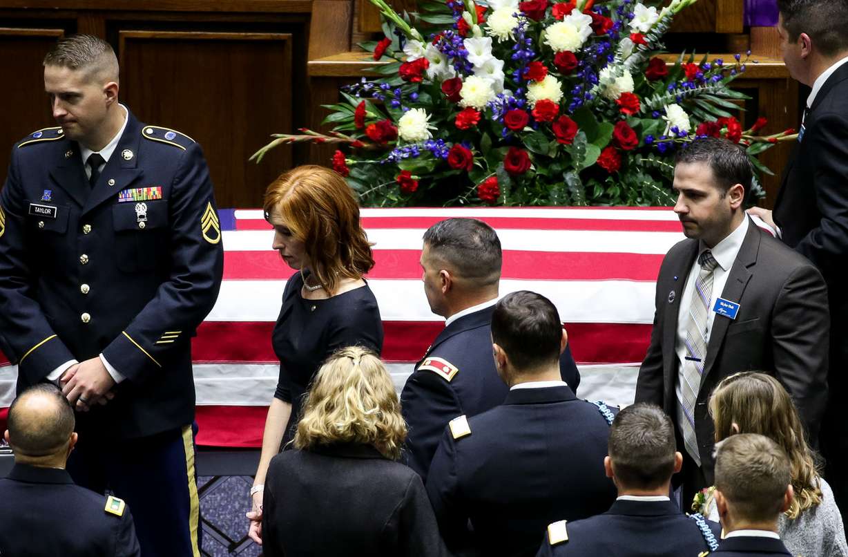Jennie Taylor, wife of Maj. Brent Taylor, walks past his flag-draped casket before the start of his funeral at the Dee Events Center in Ogden on Saturday, Nov. 17, 2018. (Photo: Spenser Heaps, KSL)